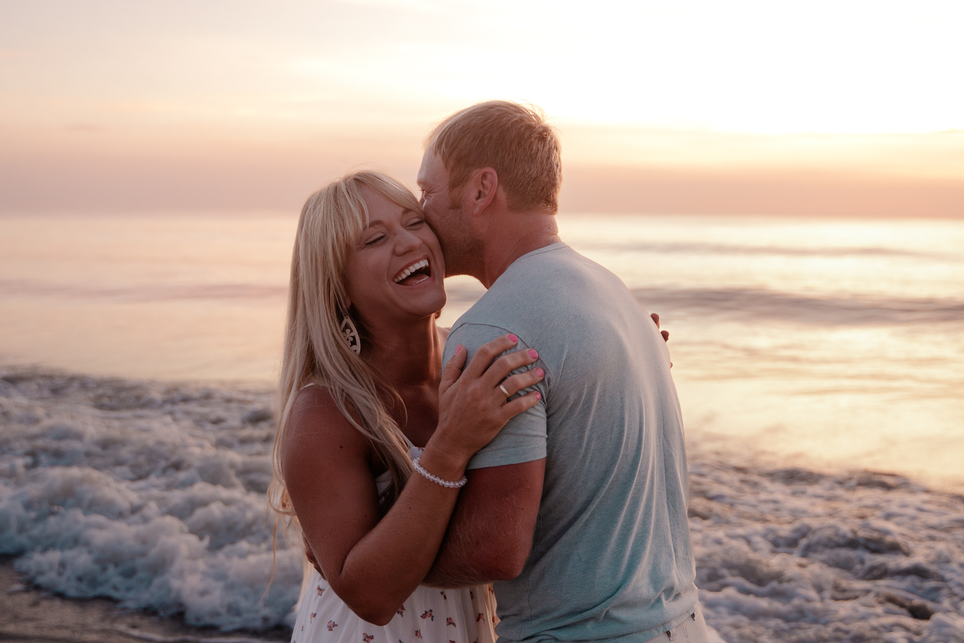 Couple laughing together during sunrise beach session at Flagler Beach Florida