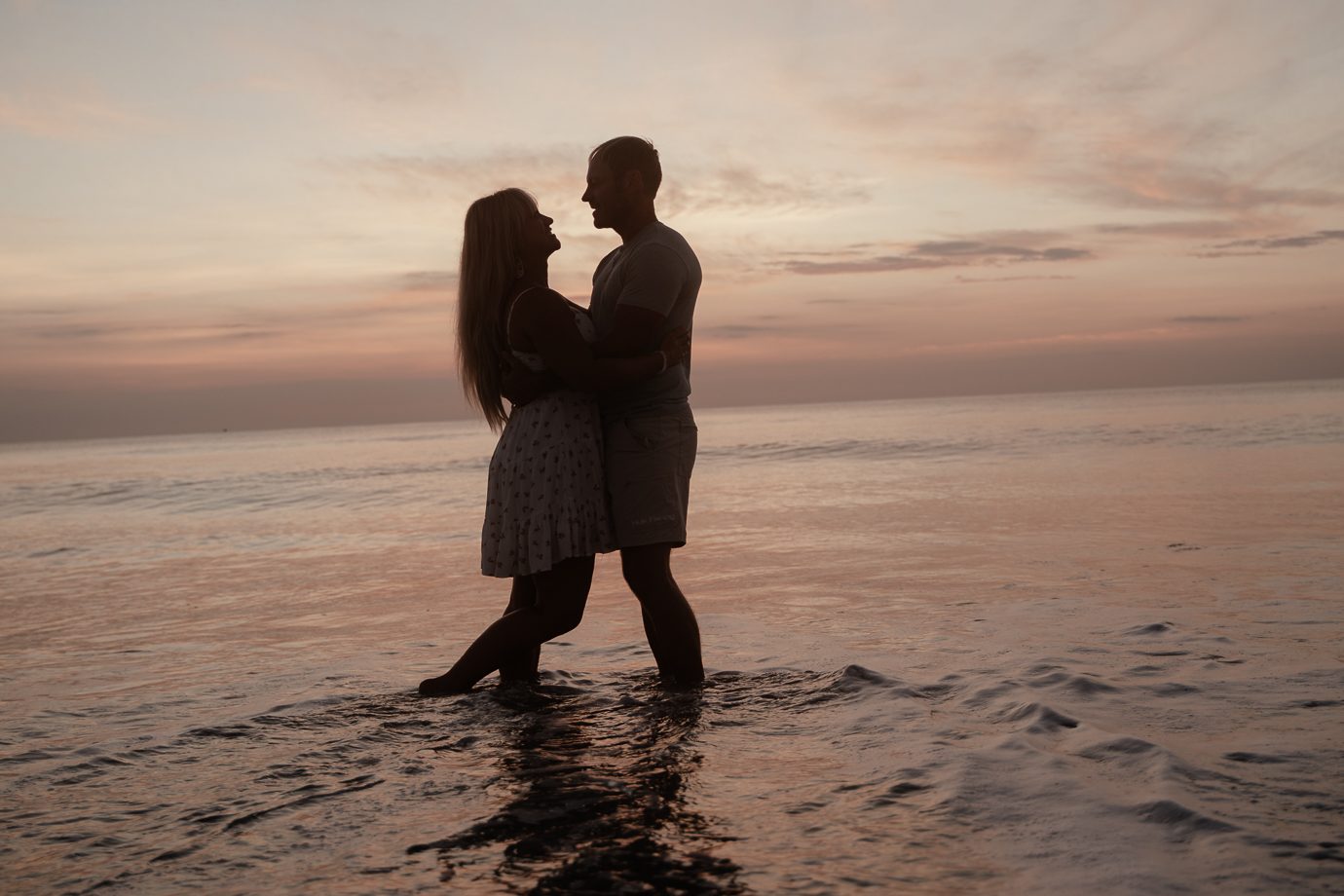 Couple smiling and holding hands at Flagler Beach sunrise session