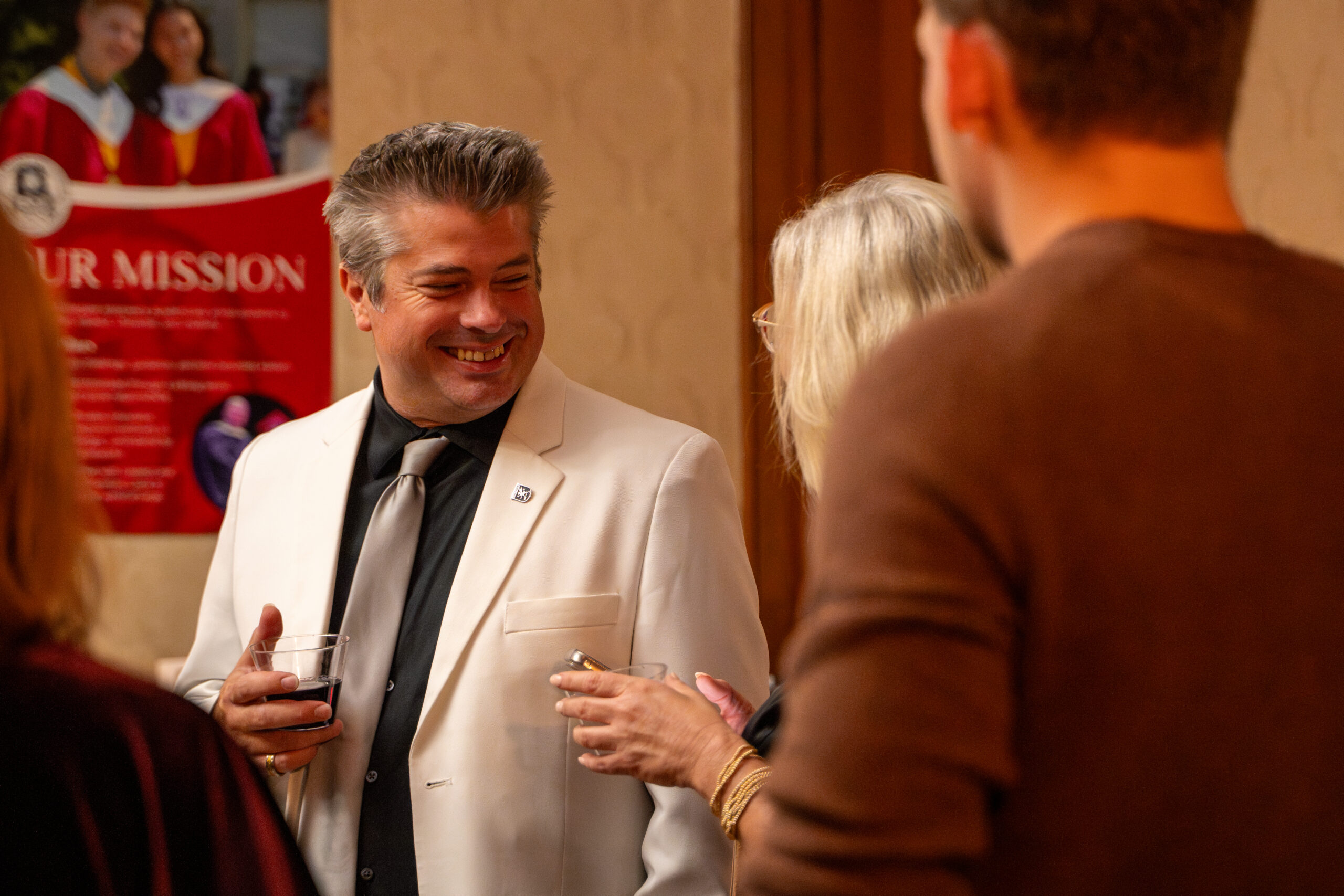 Guests smiling beside fall florals inside Rivermont Mansion