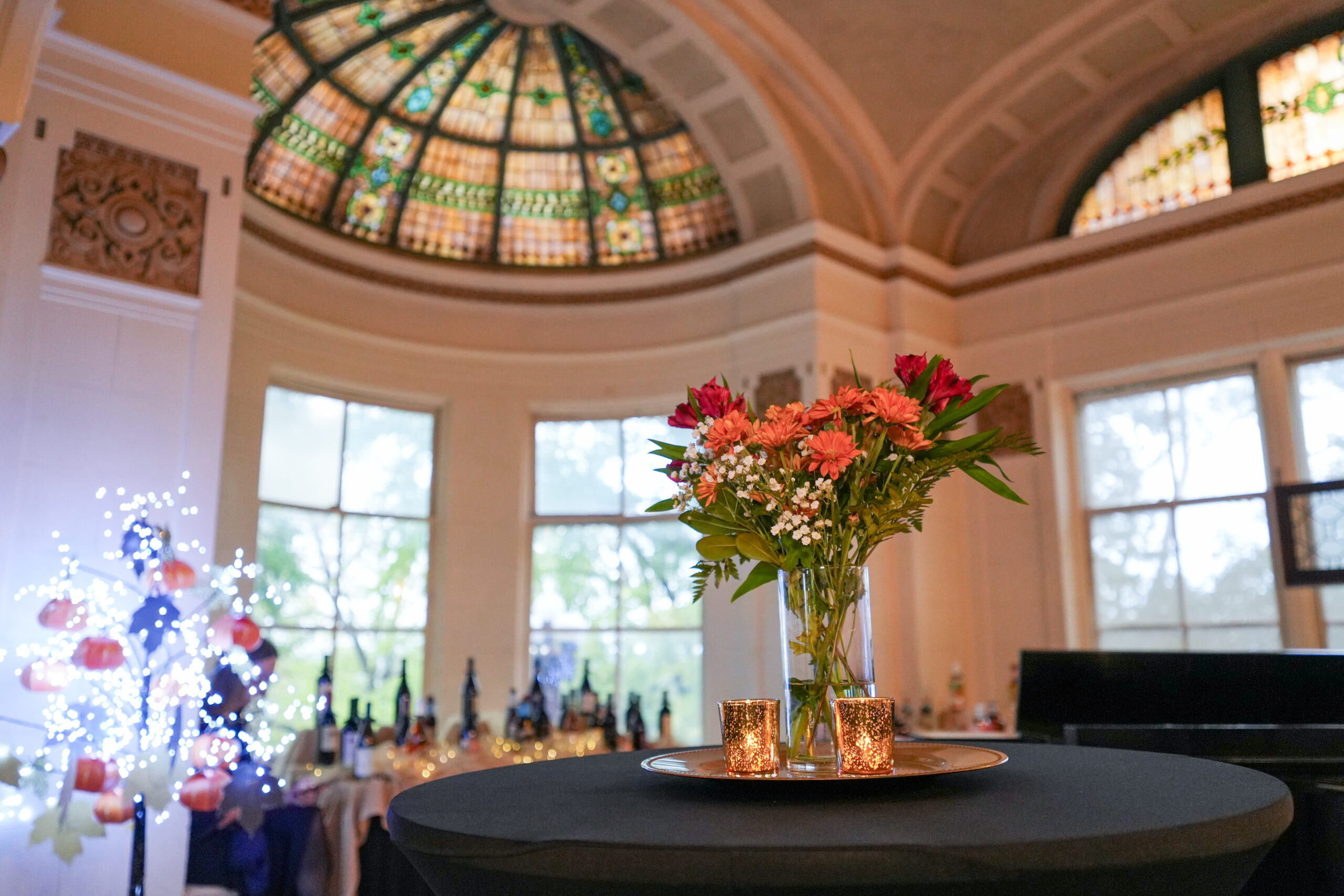 Stained glass ceiling and windows at Rivermont Mansion glowing at dusk