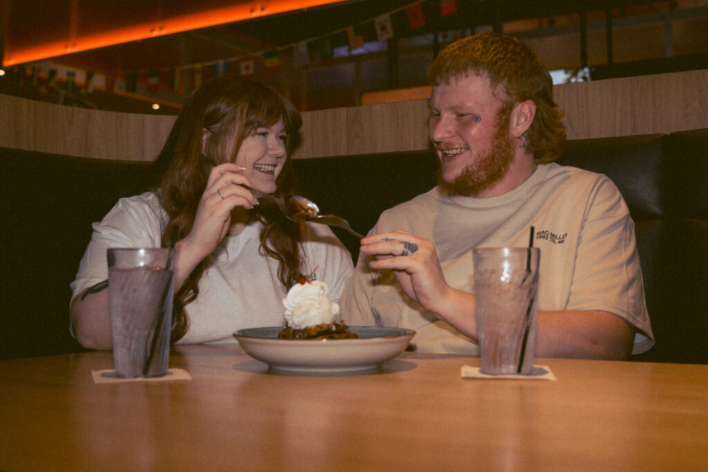 Couple sharing a sweet dessert during their Davenport Iowa engagement photos
