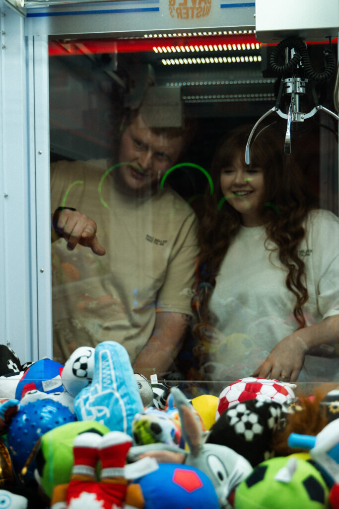 Engaged couple having fun during an arcade date night photo session