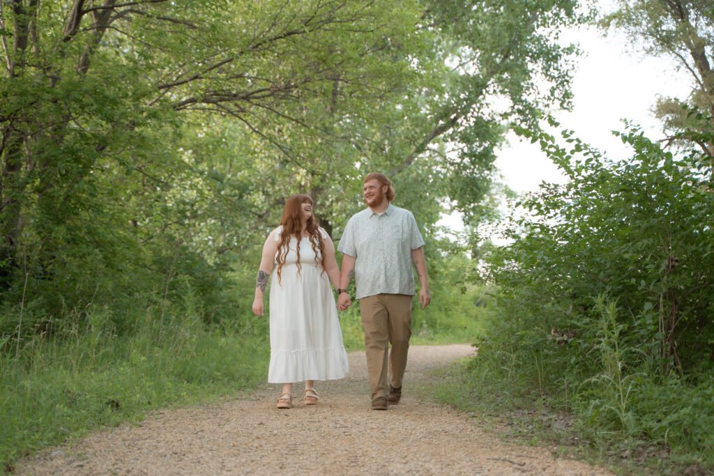 Candid and romantic outdoor engagement photo of a couple walking together