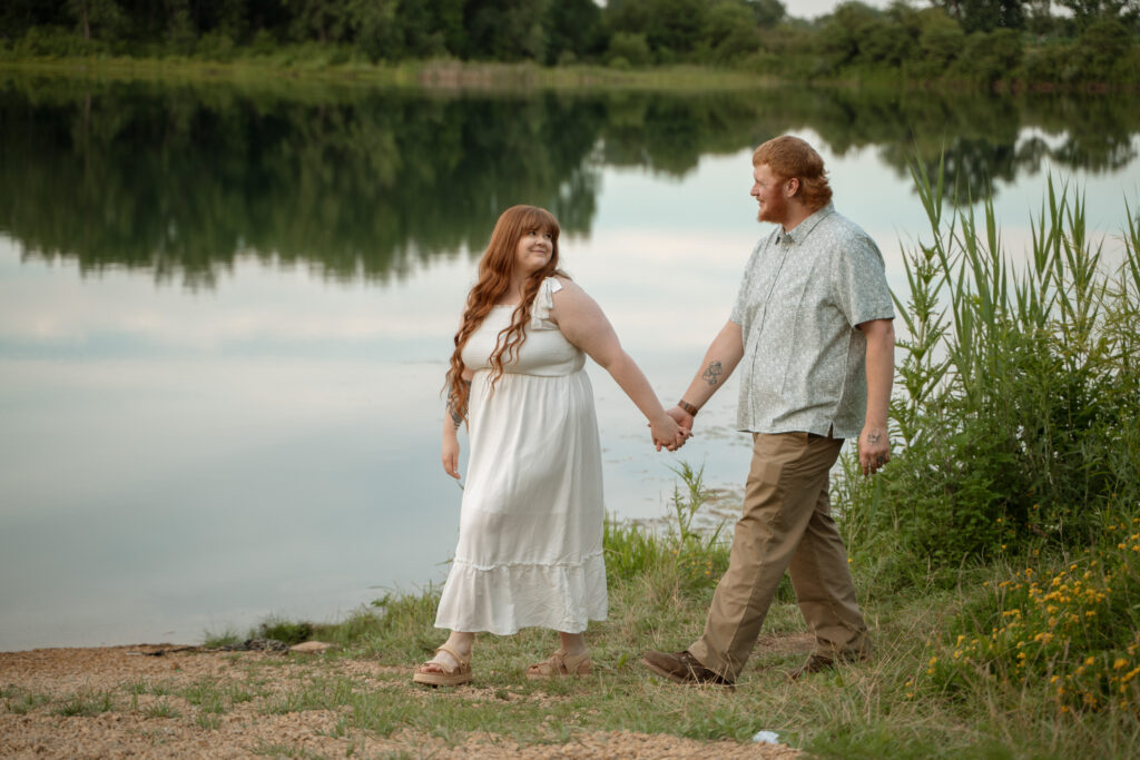 Romantic outdoor engagement photo of a couple by the water